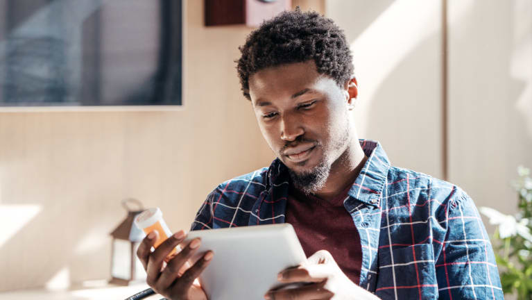 Young man reading medication information