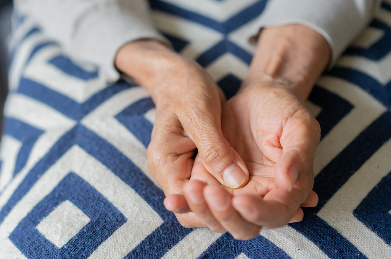Close up of an elderly woman's hands, for Parkinson's tremor concept. 