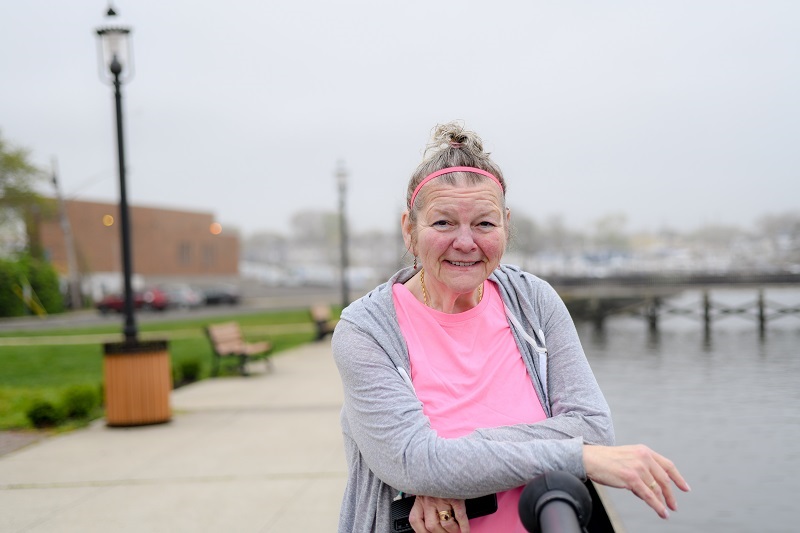 Linda Shorafa standing by the waterway, smiling.