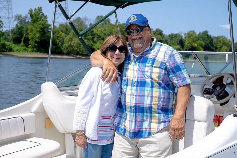Patient Tomas Marrero and wife Eva, smiling on a boat.