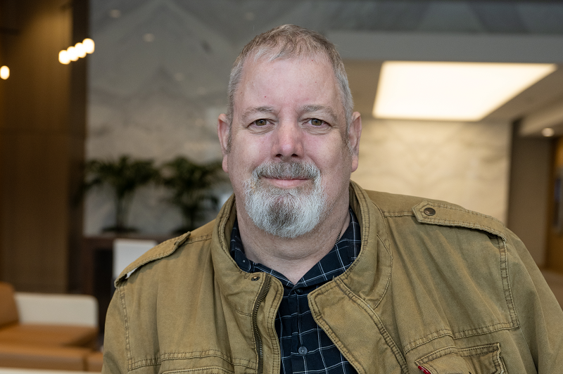 Glenn Personette standing and smiling. 