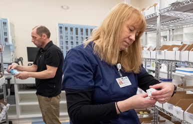 Man and women sorting out pills