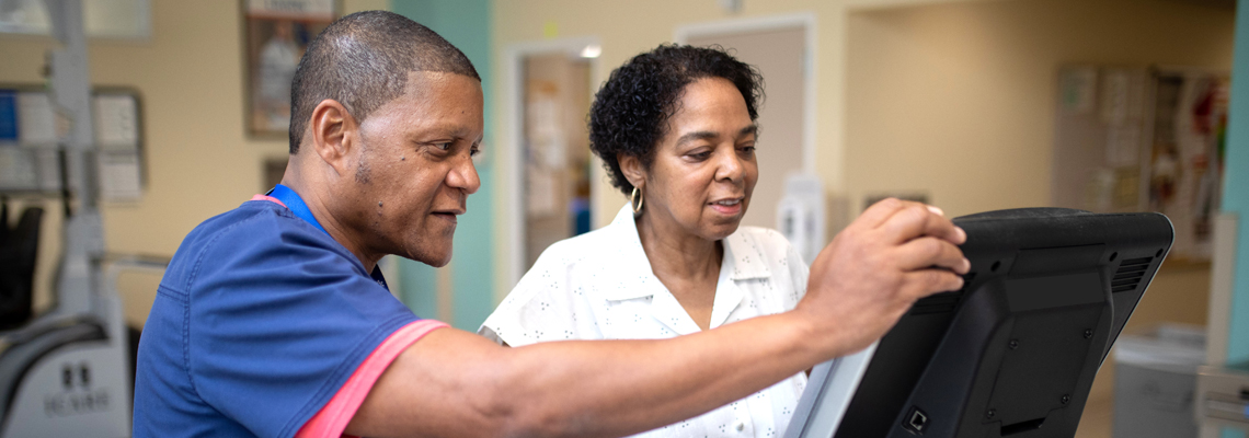 woman on a treadmill with a provider beside her